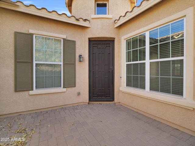 property entrance featuring a patio