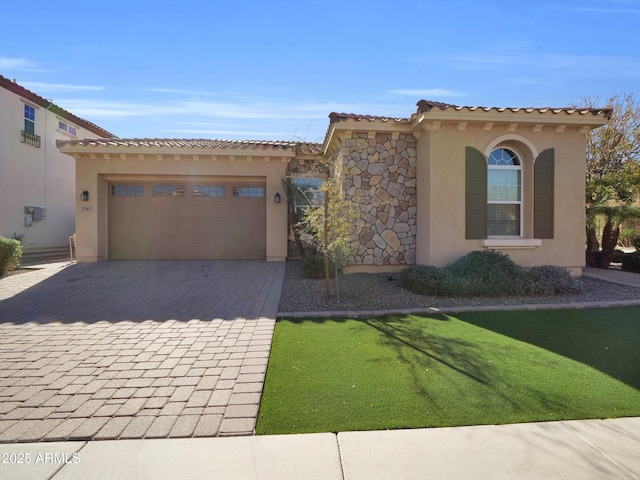 mediterranean / spanish home with a garage and a front yard