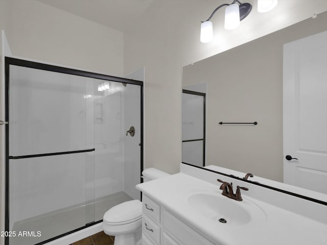 bathroom with vanity, toilet, and walk in shower