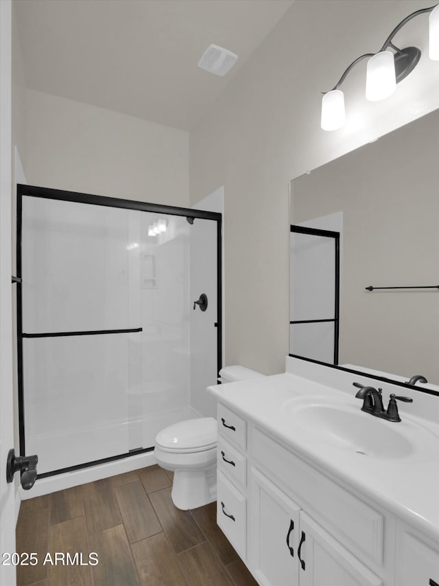 bathroom with vanity, toilet, and walk in shower