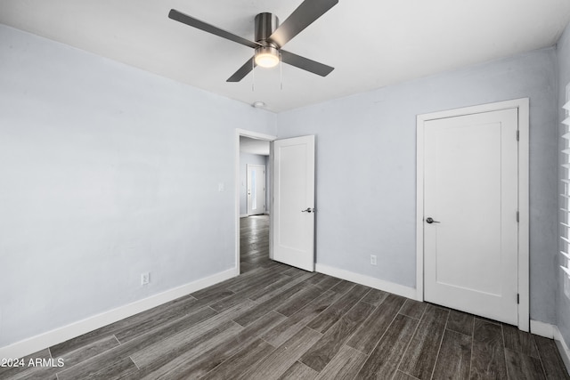 unfurnished bedroom featuring ceiling fan and dark wood-type flooring