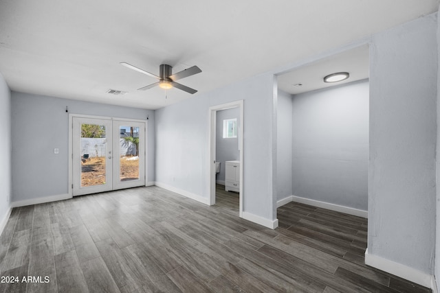 empty room with ceiling fan, dark hardwood / wood-style flooring, and french doors