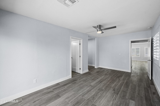 empty room featuring ceiling fan and dark hardwood / wood-style flooring