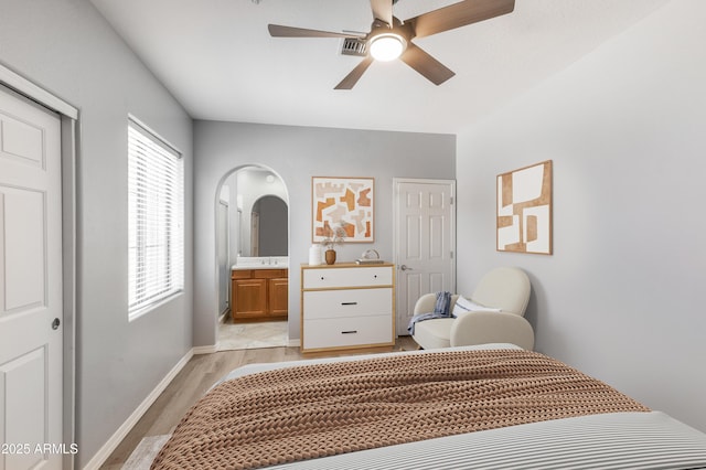 3935 E Rough Rider Rd Unit 1039, Phoenix, AZ 85050 - bedroom with light wood-style flooring, connected bathroom, baseboards, ceiling fan, and a closet