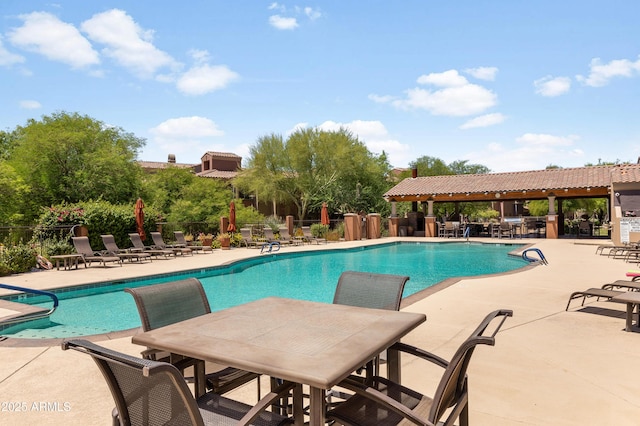 3935 E Rough Rider Rd Unit 1039, Phoenix, AZ 85050 - community pool featuring a patio and outdoor dining space