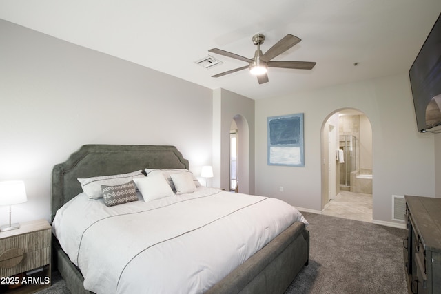 3935 E Rough Rider Rd Unit 1039, Phoenix, AZ 85050 - bedroom featuring arched walkways, light colored carpet, baseboards, ceiling fan, and ensuite bathroom