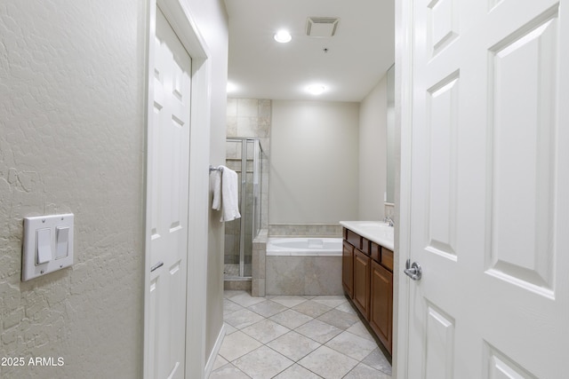 3935 E Rough Rider Rd Unit 1039, Phoenix, AZ 85050 - bathroom with tile patterned flooring, a garden tub, a stall shower, vanity, and a textured wall
