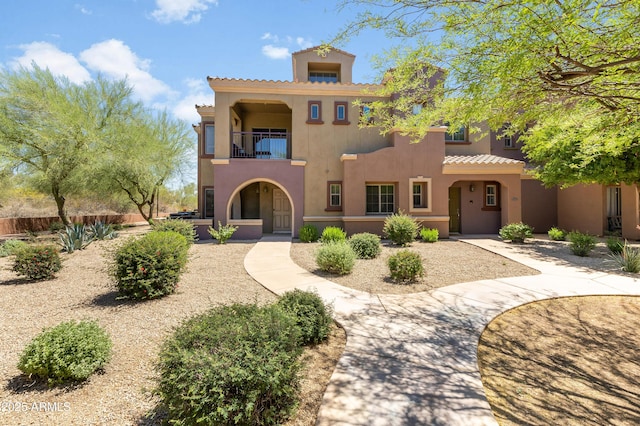 3935 E Rough Rider Rd Unit 1039, Phoenix, AZ 85050 - mediterranean / spanish house with a balcony, stucco siding, and a tiled roof