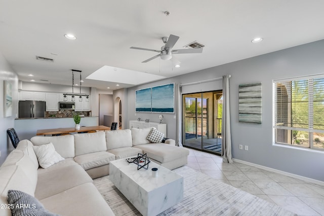 3935 E Rough Rider Rd Unit 1039, Phoenix, AZ 85050 - living room with baseboards, ceiling fan, recessed lighting, arched walkways, and light marble finish floors
