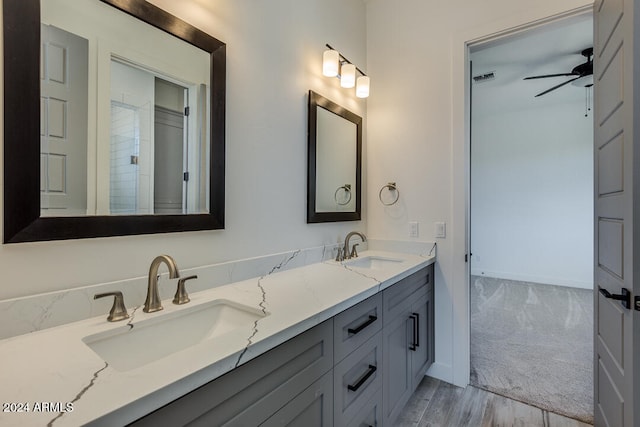 bathroom with hardwood / wood-style floors, vanity, and ceiling fan