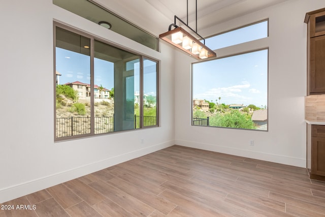 unfurnished dining area with light hardwood / wood-style floors