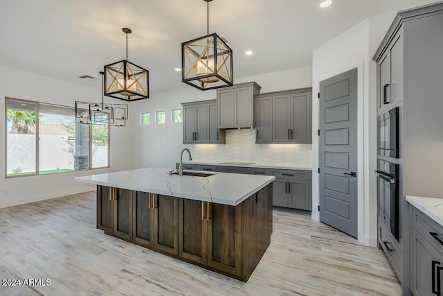 15522 E Chicory Dr, Fountain Hills, AZ 85268 - kitchen featuring a sink, black appliances, gray cabinetry, light wood-style floors, and recessed lighting