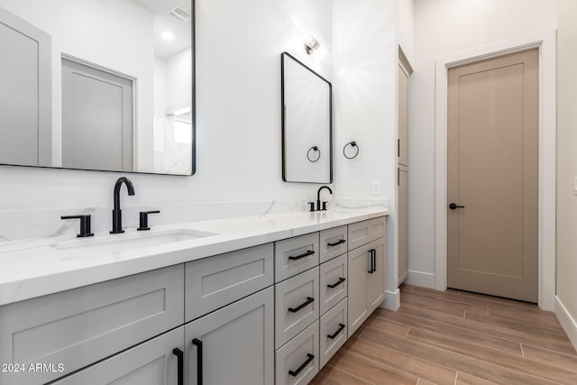 bathroom with hardwood / wood-style floors and vanity