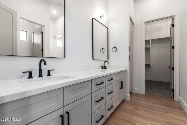 15522 E Chicory Dr, Fountain Hills, AZ 85268 - bathroom featuring double vanity, wood finished floors, baseboards, and a walk in closet