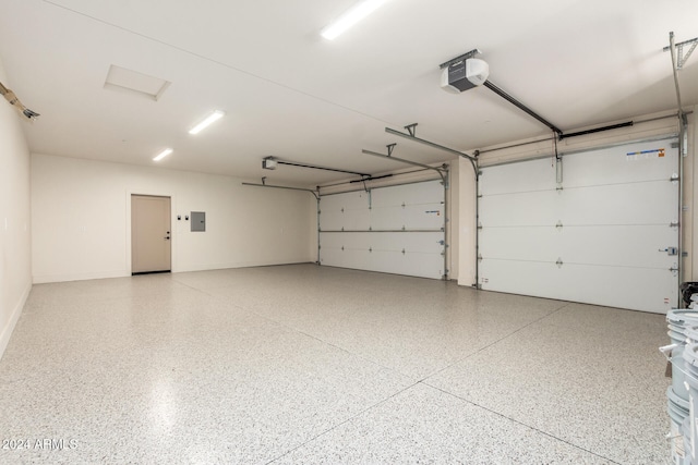 garage featuring electric panel and a garage door opener