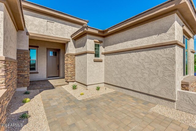 15522 E Chicory Dr, Fountain Hills, AZ 85268 - view of exterior entry featuring stucco siding, stone siding, and a patio