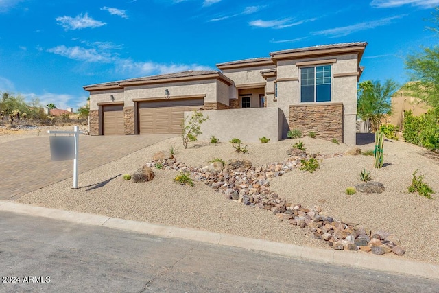 15522 E Chicory Dr, Fountain Hills, AZ 85268 - prairie-style house with stucco siding, stone siding, decorative driveway, and a garage