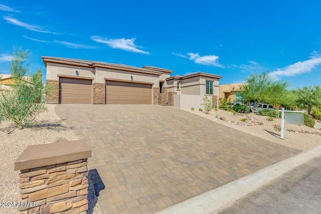 15522 E Chicory Dr, Fountain Hills, AZ 85268 - prairie-style home with stucco siding, an attached garage, decorative driveway, and stone siding