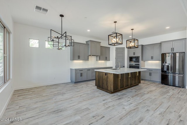 15522 E Chicory Dr, Fountain Hills, AZ 85268 - kitchen with stainless steel appliances, gray cabinetry, a chandelier, light countertops, and light wood finished floors