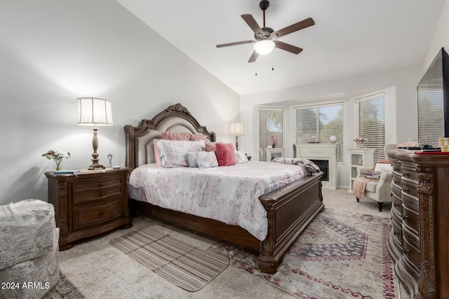 carpeted bedroom featuring vaulted ceiling and ceiling fan