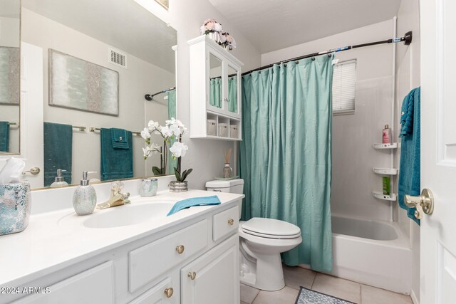 full bathroom featuring shower / bath combo, toilet, vanity, and tile patterned floors