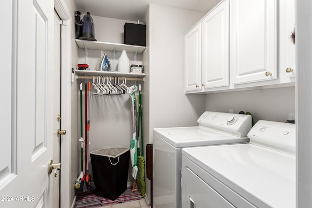 laundry area featuring cabinets and washer and clothes dryer