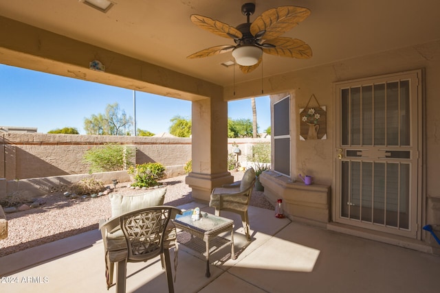 sunroom featuring ceiling fan