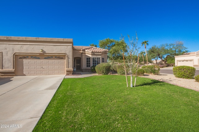 view of front of house featuring a garage and a front lawn