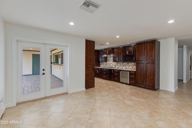 kitchen with dark brown cabinetry, visible vents, french doors, appliances with stainless steel finishes, and tasteful backsplash