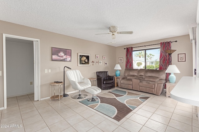 tiled living room with ceiling fan and a textured ceiling