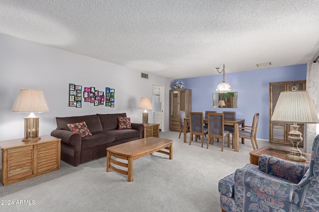 living room with light carpet and a textured ceiling