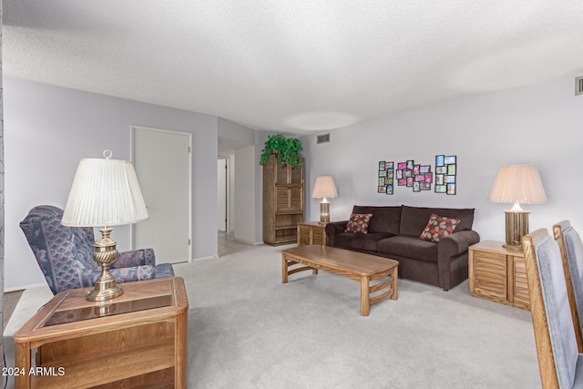 living room with light carpet and a textured ceiling