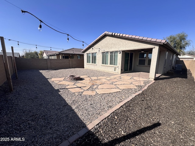 back of house with a patio and a fire pit