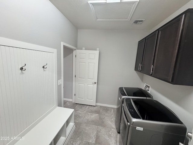 laundry room with cabinets and washing machine and clothes dryer