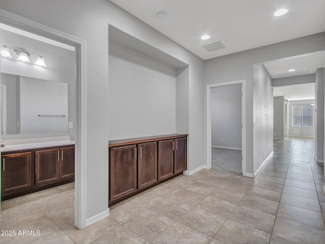 hall featuring light tile patterned flooring