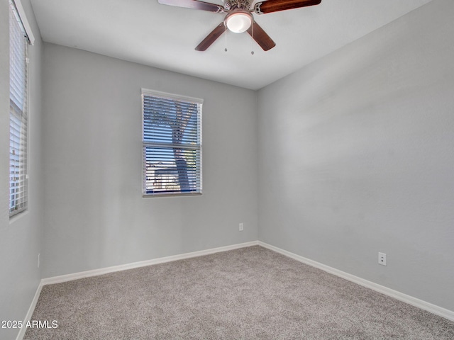 unfurnished room featuring ceiling fan and carpet floors