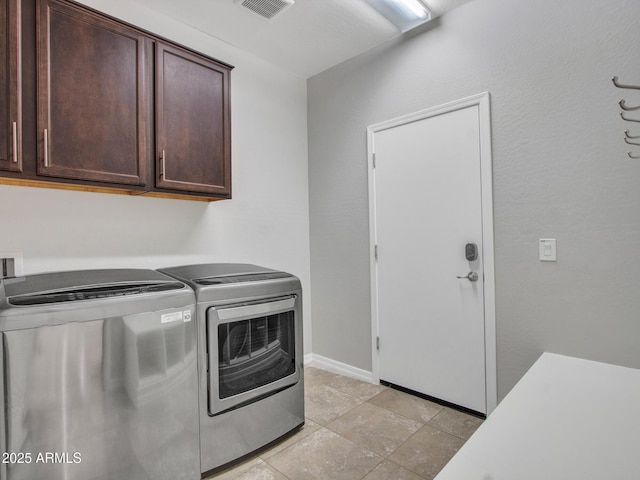 laundry area featuring cabinets and separate washer and dryer