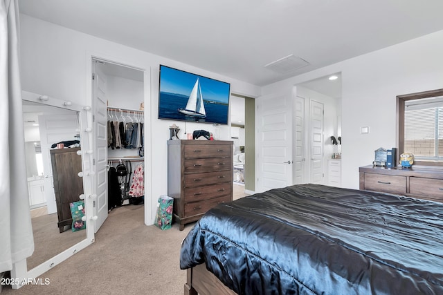 carpeted bedroom with connected bathroom and a closet