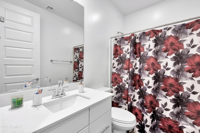 bathroom featuring vanity, toilet, and a shower with shower curtain