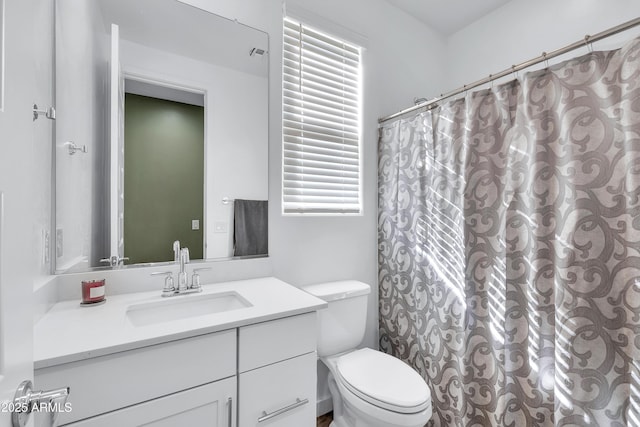 bathroom featuring a shower with curtain, vanity, and toilet