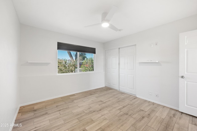 unfurnished bedroom with ceiling fan, light hardwood / wood-style flooring, and a closet