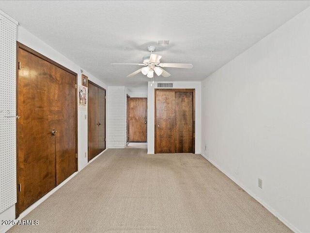 7232 N 22 Nd St, Phoenix, AZ 85020 - unfurnished bedroom featuring multiple closets, light colored carpet, and ceiling fan