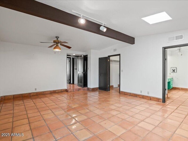7232 N 22 Nd St, Phoenix, AZ 85020 - spare room featuring rail lighting, light tile patterned flooring, baseboards, beamed ceiling, and a ceiling fan