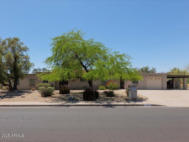 7232 N 22 Nd St, Phoenix, AZ 85020 - view of property hidden behind natural elements with a garage, driveway, and an attached carport
