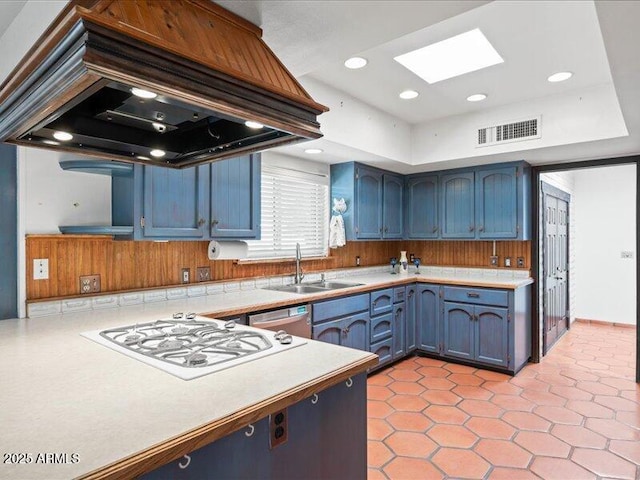 7232 N 22 Nd St, Phoenix, AZ 85020 - kitchen with a sink, white gas cooktop, island exhaust hood, a skylight, and blue cabinetry