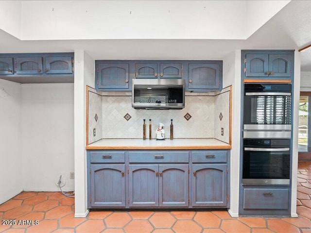 7232 N 22 Nd St, Phoenix, AZ 85020 - kitchen with appliances with stainless steel finishes, light countertops, decorative backsplash, and light tile patterned flooring
