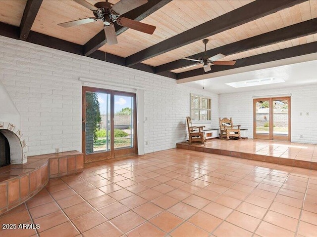 7232 N 22 Nd St, Phoenix, AZ 85020 - living room with brick wall, wooden ceiling with exposed beams, ceiling fan, light tile patterned floors, and french doors