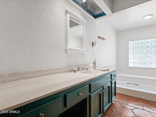 7232 N 22 Nd St, Phoenix, AZ 85020 - bathroom with vanity, a garden tub, a textured wall, and tile patterned floors