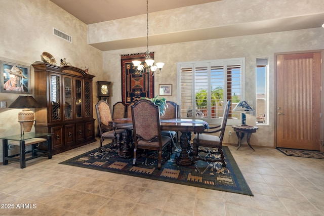 32826 N 54th St, Cave Creek, AZ 85331 - dining area featuring a chandelier, light tile patterned floors, and a towering ceiling