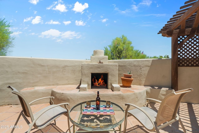 32826 N 54th St, Cave Creek, AZ 85331 - view of patio / terrace with a warm lit fireplace